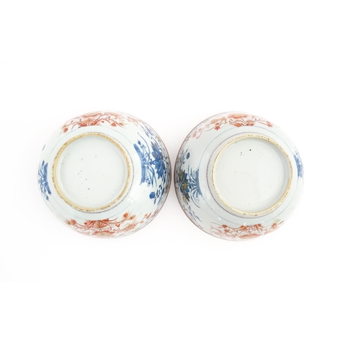 4 - A matched pair of Japanese bowls decorated in the Imari palette with flowers and foliage. Approx. 5