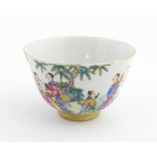 41 - A Chinese famille rose tea bowl decorated with figures in a river landscape. Character marks under. ... 