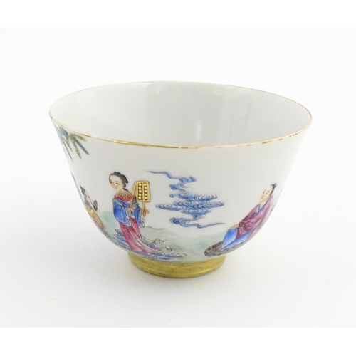 41 - A Chinese famille rose tea bowl decorated with figures in a river landscape. Character marks under. ... 