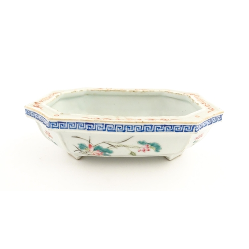 44 - A Chinese famille rose dish decorated with flowers and a Greek Key border. Approx. 7