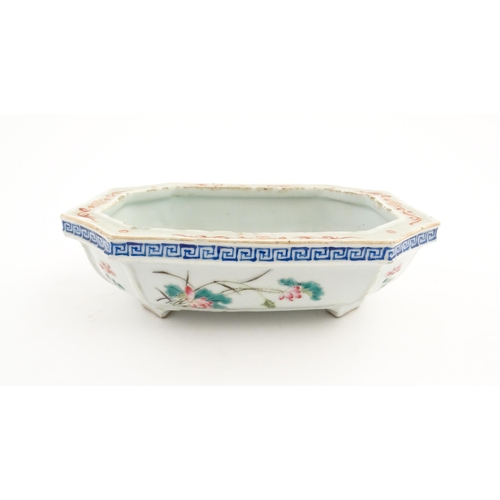 44 - A Chinese famille rose dish decorated with flowers and a Greek Key border. Approx. 7