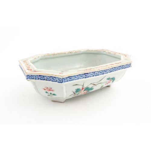 44 - A Chinese famille rose dish decorated with flowers and a Greek Key border. Approx. 7