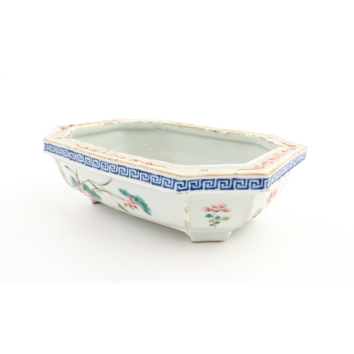 44 - A Chinese famille rose dish decorated with flowers and a Greek Key border. Approx. 7