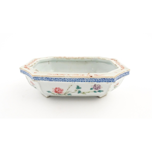 44 - A Chinese famille rose dish decorated with flowers and a Greek Key border. Approx. 7