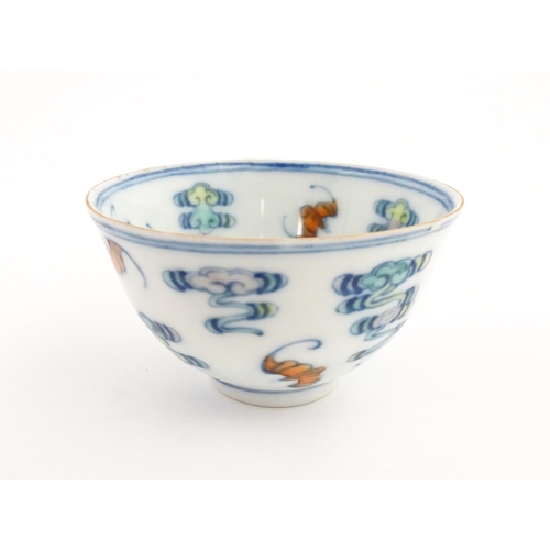 47 - A Chinese Docai tea bowl decorated with bats and stylised clouds. Character marks under. Approx. 2