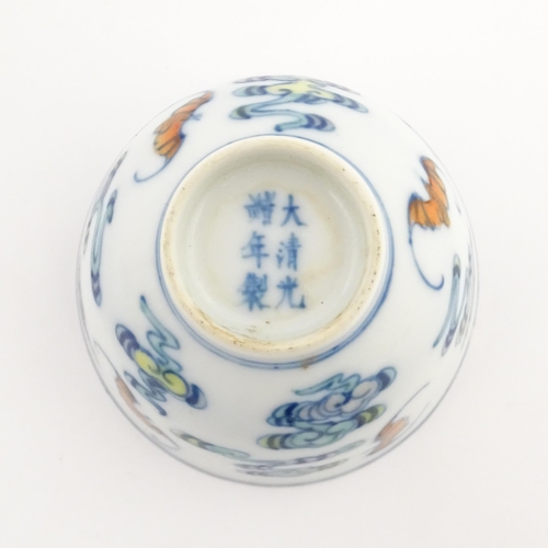 47 - A Chinese Docai tea bowl decorated with bats and stylised clouds. Character marks under. Approx. 2