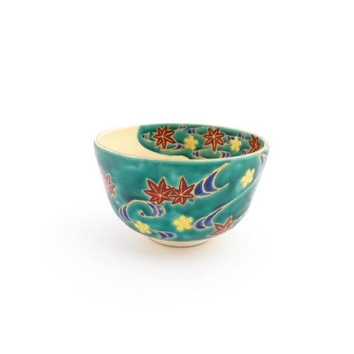 5 - A Japanese Kiyomizu studio pottery bowl, decorated with flowers. Character marks to base. Approx. 2 ... 