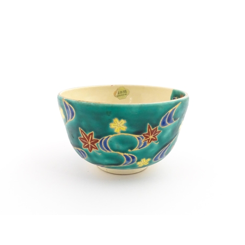 5 - A Japanese Kiyomizu studio pottery bowl, decorated with flowers. Character marks to base. Approx. 2 ... 