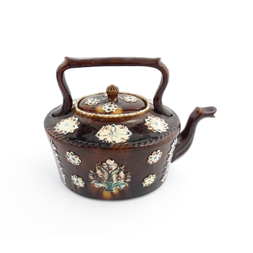 56 - A Victorian Measham bargeware teapot with applied floral and foliate motifs and motto Long Life & Ha... 