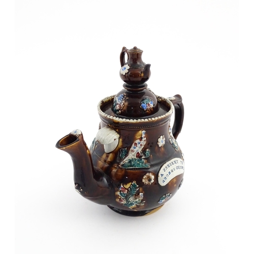 58 - A large Victorian Measham bargeware teapot with a teapot finial to lid, the body decorated with flow... 