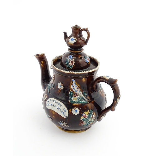 58 - A large Victorian Measham bargeware teapot with a teapot finial to lid, the body decorated with flow... 