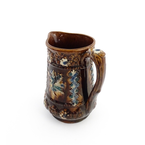 60 - A Victorian Measham bargeware jug with floral and foliate detail, with the motto Serve Me Well I'll ... 