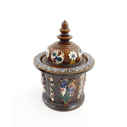 62 - A Victorian Measham bargeware advertising tobacco jar and tamper decorated with flowers and foliage ... 