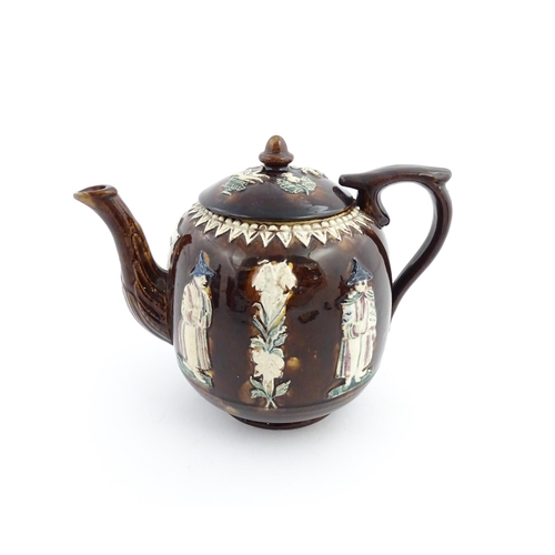 63 - A Victorian Measham bargeware teapot decorated with flowers, foliage and chinoiserie figures, with a... 