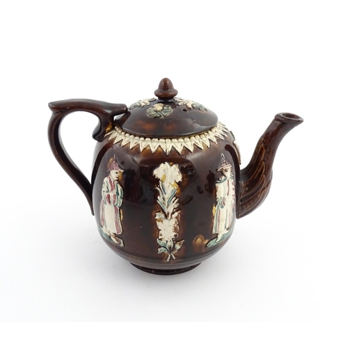 63 - A Victorian Measham bargeware teapot decorated with flowers, foliage and chinoiserie figures, with a... 