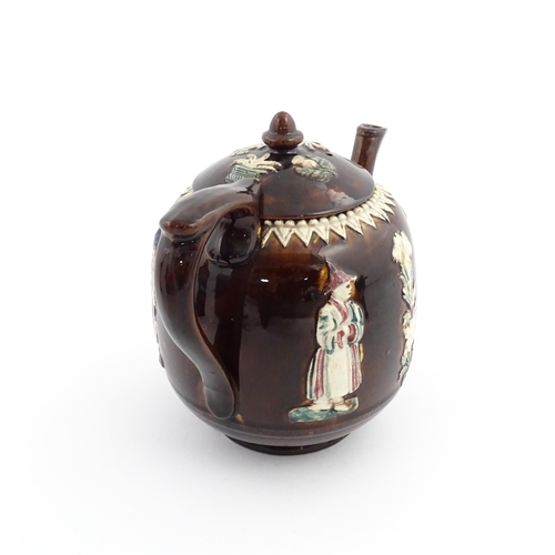 63 - A Victorian Measham bargeware teapot decorated with flowers, foliage and chinoiserie figures, with a... 