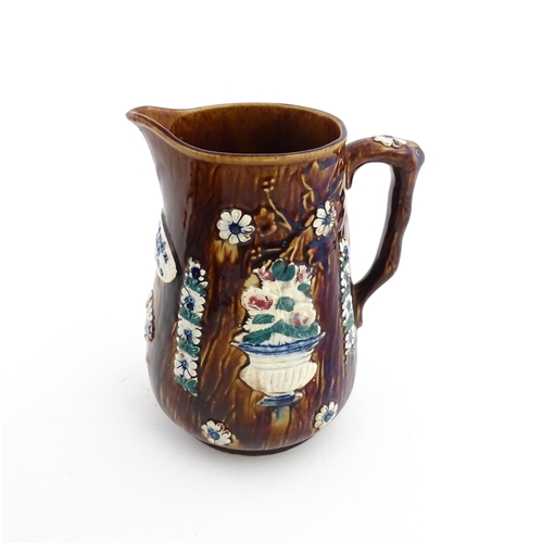 64 - A Victorian Measham bargeware jug decorated with flower, foliage and a plaque titled Mrs Butcher fro... 