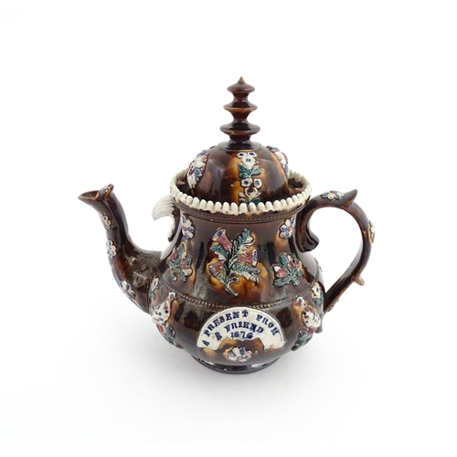 65 - A large Victorian Measham bargeware teapot decorated with applied flowers, thistles, foliage, birds ... 