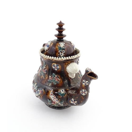 65 - A large Victorian Measham bargeware teapot decorated with applied flowers, thistles, foliage, birds ... 