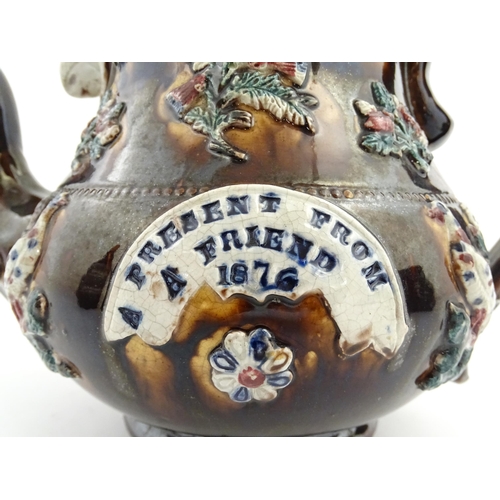 65 - A large Victorian Measham bargeware teapot decorated with applied flowers, thistles, foliage, birds ... 