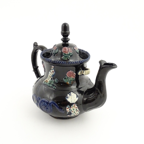 67 - A large Victorian blue Measham bargeware teapot decorated with roses, flower, birds and snakes. Appr... 