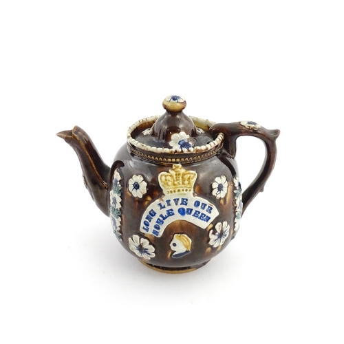 68 - A Victorian Measham bargeware teapot decorated with flowers, a profile portrait and a plaque surmoun... 