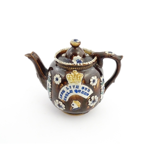 68 - A Victorian Measham bargeware teapot decorated with flowers, a profile portrait and a plaque surmoun... 