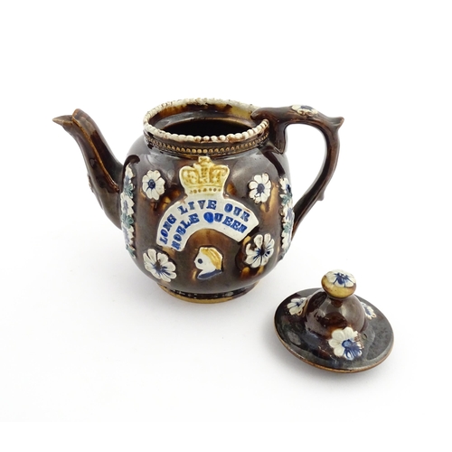 68 - A Victorian Measham bargeware teapot decorated with flowers, a profile portrait and a plaque surmoun... 