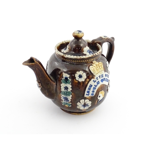 68 - A Victorian Measham bargeware teapot decorated with flowers, a profile portrait and a plaque surmoun... 