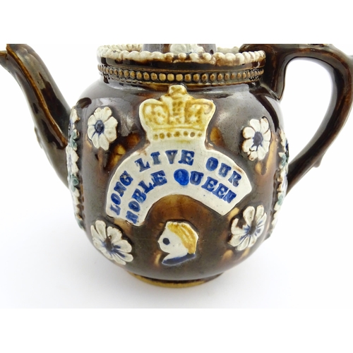 68 - A Victorian Measham bargeware teapot decorated with flowers, a profile portrait and a plaque surmoun... 