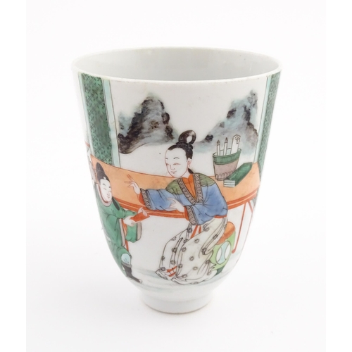 7 - A Chinese famille rose cup / beaker decorated with figures on a terrace with mountains beyond. Appro... 