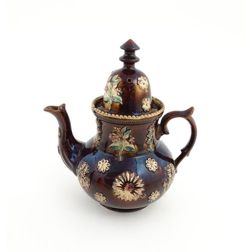 72 - A large Victorian Measham bargeware teapot decorated with flowers and foliage. Approx. 11 1/2