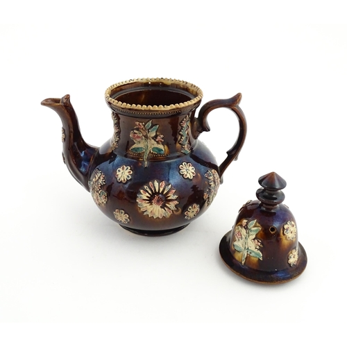 72 - A large Victorian Measham bargeware teapot decorated with flowers and foliage. Approx. 11 1/2