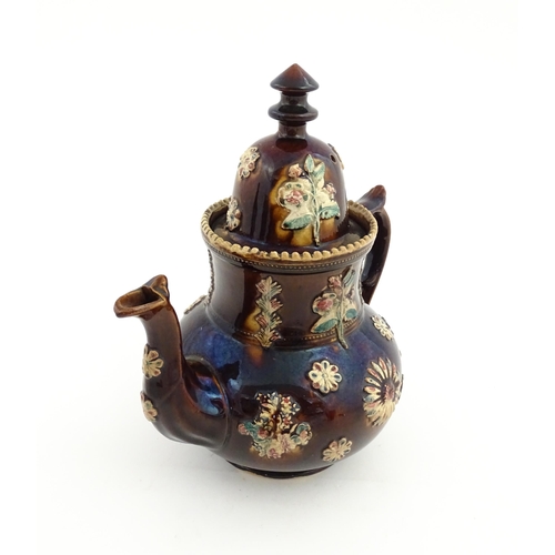 72 - A large Victorian Measham bargeware teapot decorated with flowers and foliage. Approx. 11 1/2