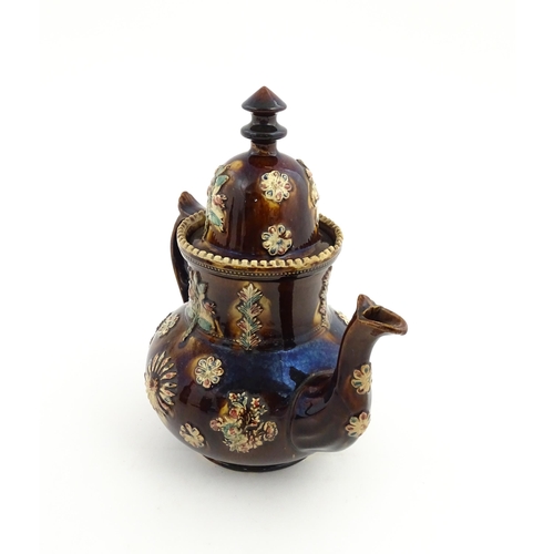 72 - A large Victorian Measham bargeware teapot decorated with flowers and foliage. Approx. 11 1/2