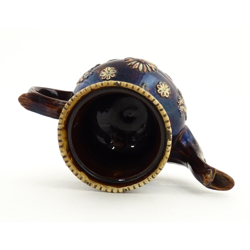 72 - A large Victorian Measham bargeware teapot decorated with flowers and foliage. Approx. 11 1/2