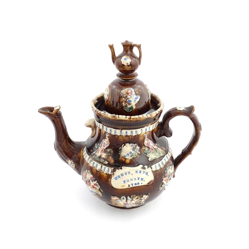 73 - A large George III Measham bargeware teapot, with teapot finial to lid, the body decorated with flow... 