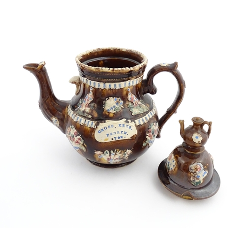 73 - A large George III Measham bargeware teapot, with teapot finial to lid, the body decorated with flow... 