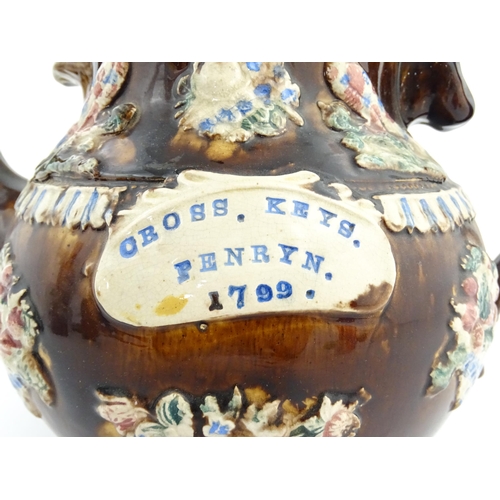 73 - A large George III Measham bargeware teapot, with teapot finial to lid, the body decorated with flow... 