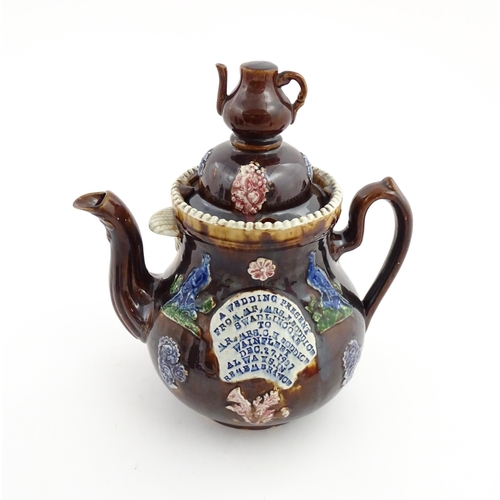 74 - A large Victorian Measham bargeware teapot, with teapot finial to lid, the body decorated with flowe... 