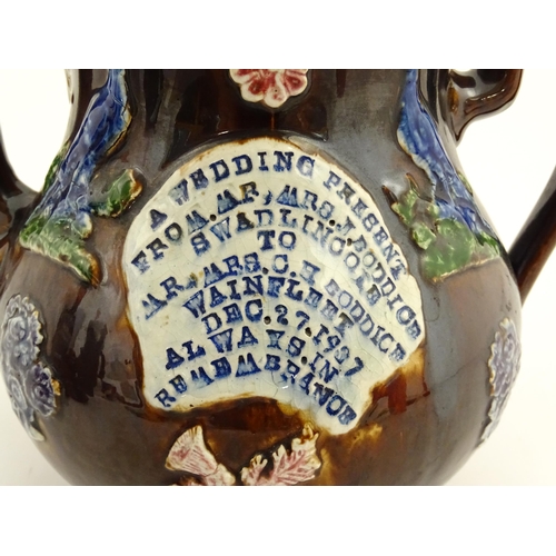 74 - A large Victorian Measham bargeware teapot, with teapot finial to lid, the body decorated with flowe... 