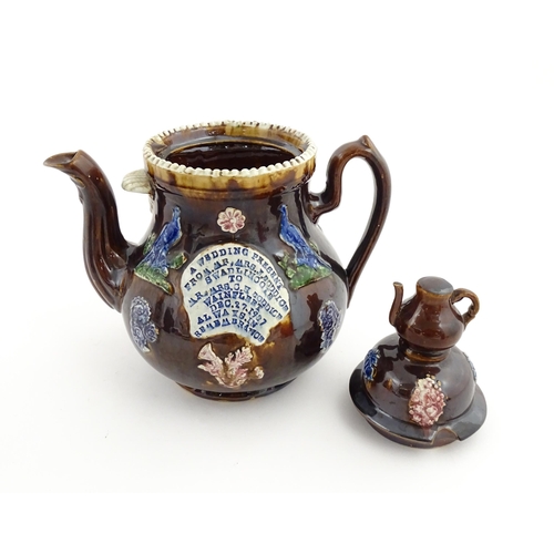 74 - A large Victorian Measham bargeware teapot, with teapot finial to lid, the body decorated with flowe... 