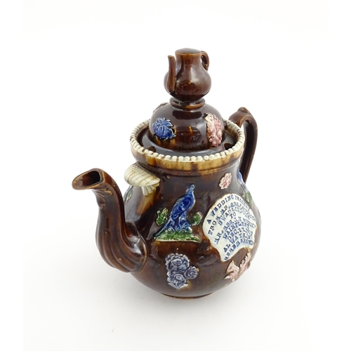 74 - A large Victorian Measham bargeware teapot, with teapot finial to lid, the body decorated with flowe... 