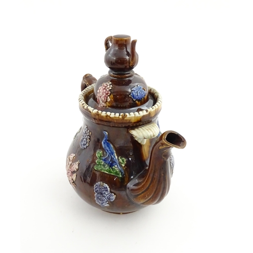 74 - A large Victorian Measham bargeware teapot, with teapot finial to lid, the body decorated with flowe... 