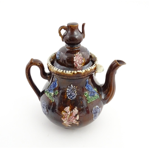 74 - A large Victorian Measham bargeware teapot, with teapot finial to lid, the body decorated with flowe... 