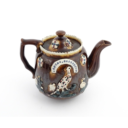 75 - Three items of Victorian Measham bargeware comprising a teapot decorated with birds and flowers with... 