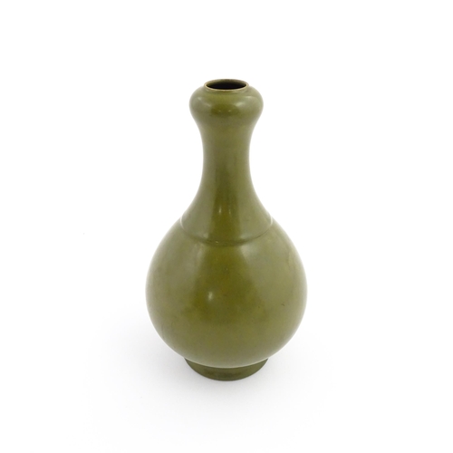 9 - A Chinese bottle vase with tea coloured glaze. Character marks under. Approx. 10 3/4