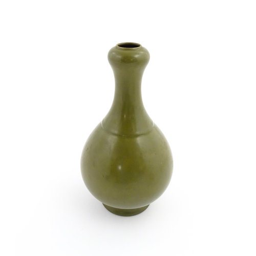 9 - A Chinese bottle vase with tea coloured glaze. Character marks under. Approx. 10 3/4