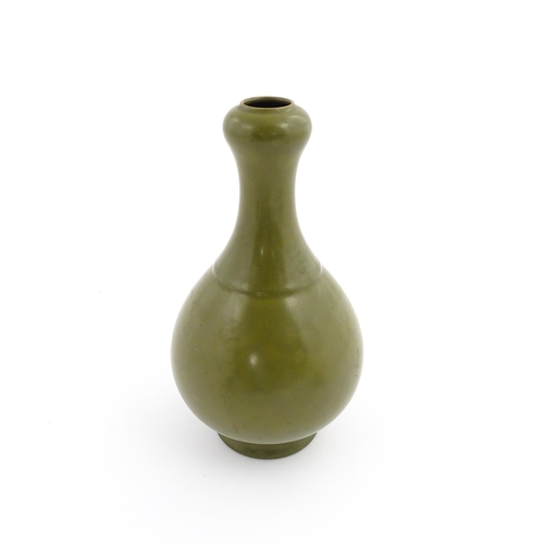 9 - A Chinese bottle vase with tea coloured glaze. Character marks under. Approx. 10 3/4