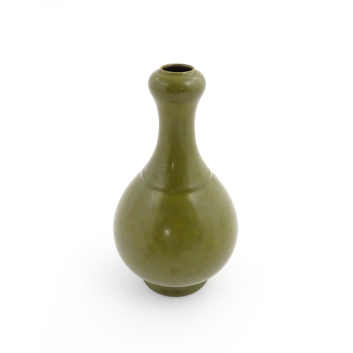 9 - A Chinese bottle vase with tea coloured glaze. Character marks under. Approx. 10 3/4